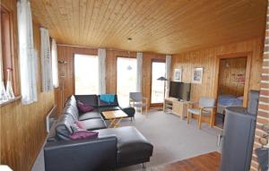 a living room with a couch and a bed at Awesome Home In Hvide Sande With Sauna in Havrvig