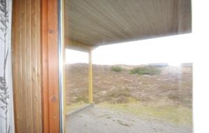 a window in a room with a view of a field at Awesome Home In Hvide Sande With Sauna in Havrvig