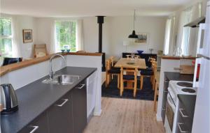 a kitchen with a sink and a dining room at Amazing Home In Hirtshals With Wifi in Hirtshals