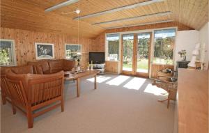 a living room with a couch and a table at Holiday Home Vestermarken Blåvand Iv in Blåvand