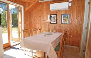 a dining room with a table in a wooden room at Holiday Home Vestermarken Blåvand Iv in Blåvand