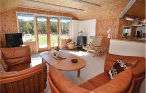 a living room with a couch and a table at Holiday Home Vestermarken Blåvand Iv in Blåvand