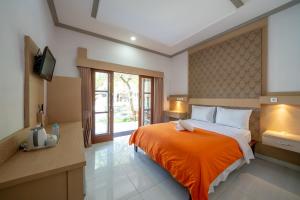 A bed or beds in a room at Bendesa Accommodation