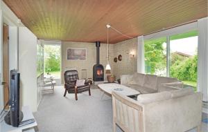 a living room with a couch and a fireplace at Amazing Home In Odder With 3 Bedrooms And Wifi in Odder