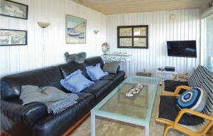 ロンストラップにあるAmazing Home In Hjrring With 3 Bedroomsのリビングルーム(黒い革張りのソファ、ガラステーブル付)