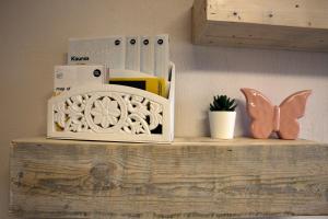 a shelf with a microwave and a butterfly on it at DP Art Residence - self check in in Kaunas