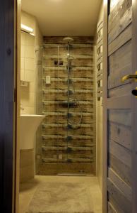 a bathroom with a shower and a sink at DP Art Residence - self check in in Kaunas +41 photos