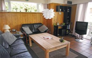 a living room with a couch and a coffee table at 3 Bedroom Nice Home In Fan in Fanø