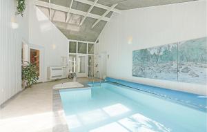 a large swimming pool in a room with a swimming pool at Beautiful Home In Grsted With Private Swimming Pool, Can Be Inside Or Outside in Udsholt Sand