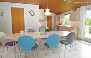 a dining room with a table and blue chairs at Amazing Home In Odder With 3 Bedrooms And Wifi in Odder
