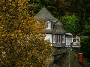 an old house with a turret on top of a house at Ferienwohnung To Hous in Monschau