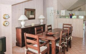 a dining room with a wooden table and chairs at Cozy Home In Vggerlse With Wifi in Bøtø By
