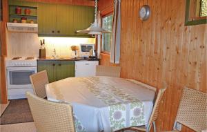 a kitchen with a table and chairs in a room at Amazing Home In Kirke Hyllinge With 3 Bedrooms in Kirke-Hyllinge