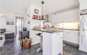 a kitchen and living room with a stove at Two-Bedroom Holiday Home In Spottrup in Spottrup