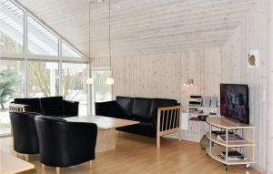 a living room with a couch and a table at Cozy Home In Vggerlse With Wifi in Bøtø By