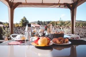 a table with plates of food on top of it at La maison des archers in Saint-Saturnin +8 photos