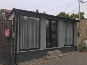 a small house with windows and a gate at CHALET Craiova in Craiova