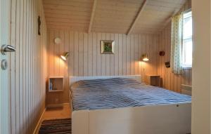 a bedroom with a large bed in a room at 2 Bedroom Awesome Home In Hovborg in Hovborg