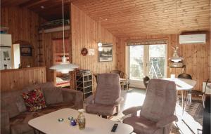 a living room with a couch and chairs and a table at Beautiful Home In Pandrup With 3 Bedrooms, Sauna And Wifi in Rødhus