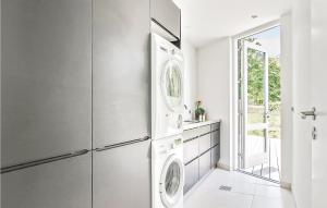 a kitchen with a refrigerator and a washer and dryer at 3 Bedroom Lovely Home In Haderslev in Kelstrup