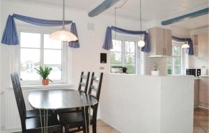 a kitchen and dining room with a table and chairs at Gorgeous Home In Bramming With Sauna in Bramming