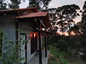 a small building with a roof on the side of it at Nature Fruit Farm - Private Estate in Balik Pulau