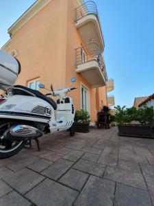 a motorcycle parked on the side of a brick building at Villa Julian in Zadar