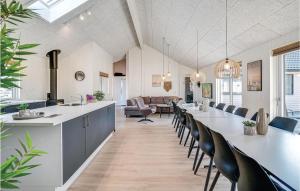 a kitchen and dining room with a long table and chairs at Lovely Home In Nørre Nebel With Wifi in Nørre Nebel