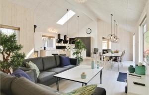 a living room with a couch and a table at Holiday Home Nexø With Fireplace 04 in Snogebæk