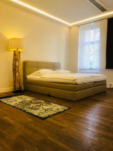 a bedroom with a bed and a window and a rug at Jasper's Boutique Hotel in Berlin