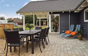 a dining table and chairs on a patio at Beautiful Home In Sydals With Wifi in Høruphav