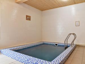 a swimming pool in a room with a tiled floor at Hotel Katyusha in Moscow