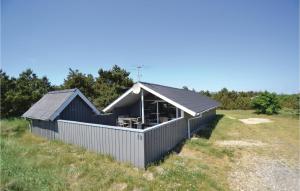 BjerregårdにあるAwesome Home In Hvide Sande With Wifiの畑の大黒い建物