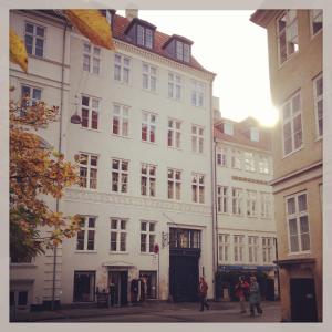 a large white building with people standing in front of it at Nyhavn Apartment in Copenhagen
