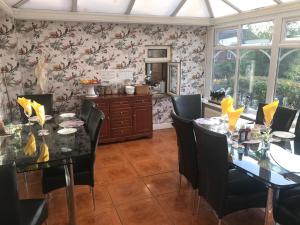 a dining room with a table and chairs at Redwood Lodge in Westbury