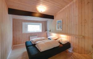 ein Schlafzimmer mit einem Bett mit Kissen darauf in der Unterkunft Four-Bedroom Holiday Home In Nexo in Vester Sømarken