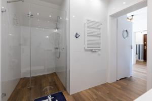 a bathroom with a shower with a glass door at Amare Apartments B1 in Mosty