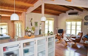 a living room with wooden walls and wooden ceilings at Holiday Home Bøtø Ringvej in Marielyst +5 photos