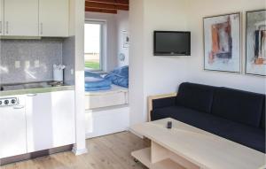 LøgumklosterにあるBeautiful Apartment In Lgumkloster With Wifi And Outdoor Swimming Poolの小さなリビングルーム(ソファ付)、キッチンが備わります。