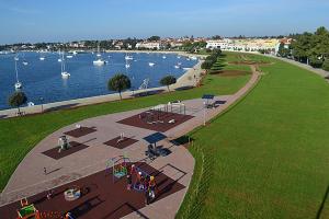 a rendering of a park next to a river with boats at Apartments and Rooms PUNTA in Umag