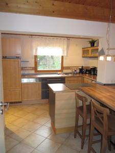 a kitchen with wooden cabinets and a counter top at Buchenweg 20a in Isenbüttel