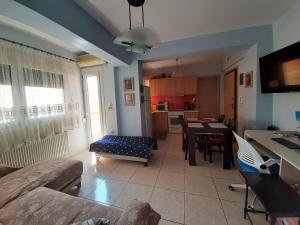 a living room with a couch and a table at Apartment with Balcony and Parking in Kavála