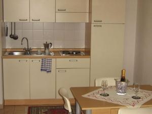 a kitchen with a table with a bottle of wine at Residenza San Giovanni in San Giovanni Valdarno