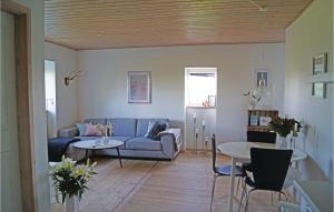 a living room with a couch and a table at Nice Apartment In Middelfart With 1 Bedrooms And Wifi in Middelfart