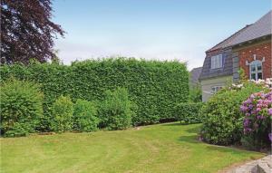 a hedge in front of a house with a yard at Stunning Apartment In Middelfart With Kitchen in Middelfart