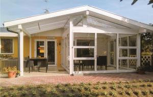 an orangery with glass doors and a patio at 3 Bedroom Gorgeous Home In Vggerlse in Marielyst