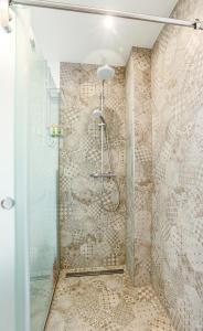 a shower with a glass door in a bathroom at MALAT Ferienhaus in Furth