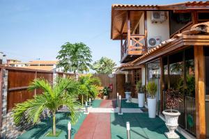 a courtyard with palm trees and a building at Ndussole House in Talatona