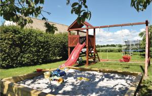 a playground in the sand with a swing at Amazing Apartment In Juelsminde With 2 Bedrooms And Wifi in Juelsminde