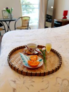 a tray with a cup of coffee and oranges on a bed at Beach View Ballycastle Escape in Ballycastle